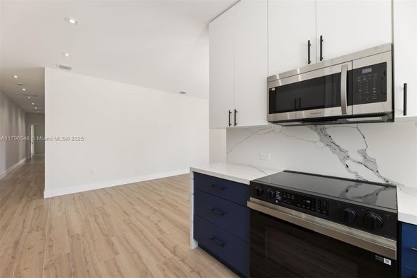 Interior, Kitchen, Marble Walls, Recessed Lighting, Stainless Steel Appliances, Wood Texture Flooring