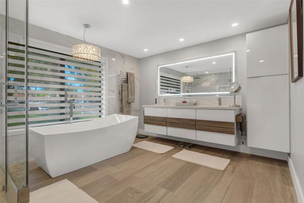 Bathroom, Free Standing Baths, Glass Shower, Interior, Marble Walls, Pendant Lights, Recessed Lighting, Wood Texture Flooring