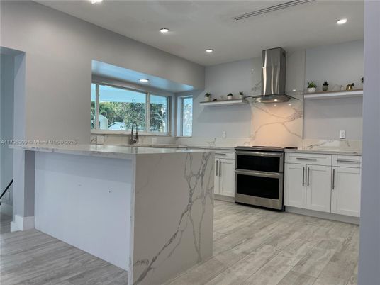 Interior, Kitchen, Marble Walls, Recessed Lighting, Stainless Steel Appliances, Wood Texture Flooring