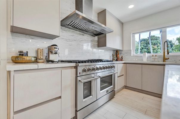 Interior, Kitchen, Marble Walls, Recessed Lighting, Stainless Steel Appliances, Wood Texture Flooring
