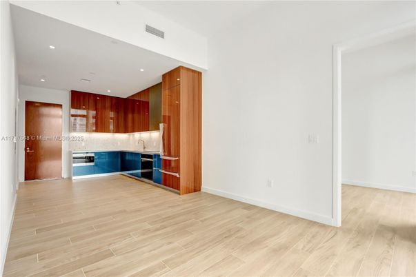 Empty room, Interior, Kitchen, Recessed Lighting, Stainless Steel Appliances, Wood Texture Flooring