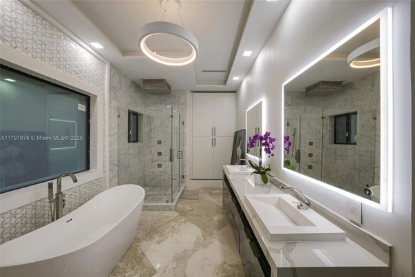 Bathroom, Dual Sink Vanities, Free Standing Baths, Glass Shower, Interior, Marble Walls, Pendant Lights, Recessed Lighting, Stone Walls