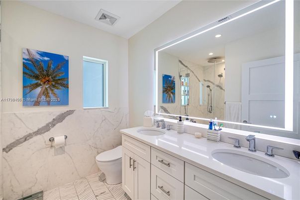 Bathroom, Dual Sink Vanities, Glass Shower, Interior, Marble, Marble Walls, Recessed Lighting