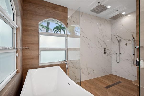 Bathroom, Free Standing Baths, Glass Shower, Interior, Marble Walls, Recessed Lighting, Wood Texture Flooring