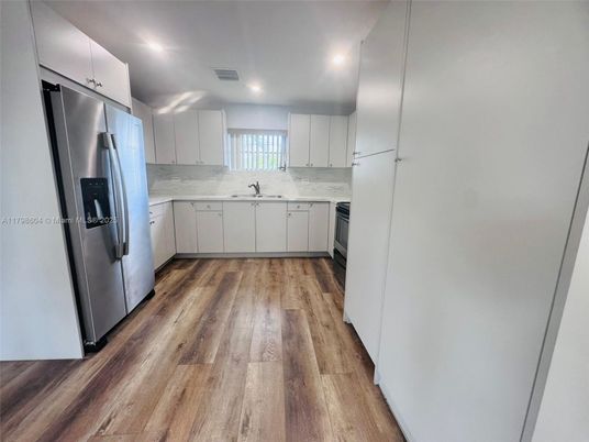 Interior, Kitchen, Marble Walls, Recessed Lighting, Stainless Steel Appliances, Wood Texture Flooring
