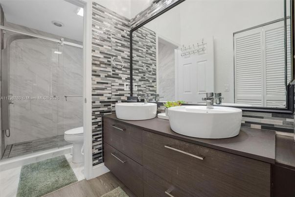 Bathroom, Dual Sink Vanities, Glass Shower, Interior, Marble Walls, Wood Texture Flooring
