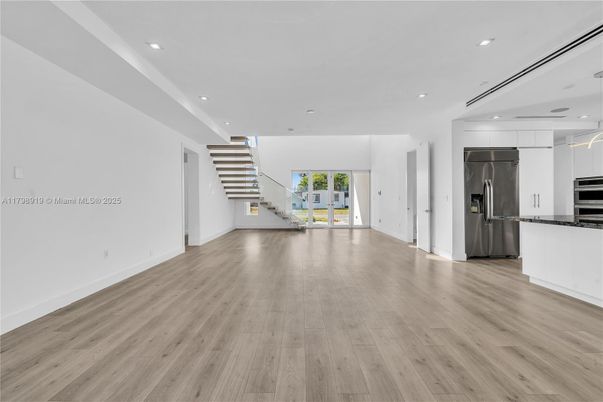 Empty room, Interior, Kitchen, Recessed Lighting, Stainless Steel Appliances, Wood Texture Flooring