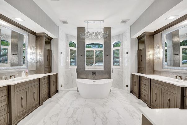 Bathroom, Chandelier, Dual Sink Vanities, Free Standing Baths, Interior, Marble, Marble Walls, Recessed Lighting