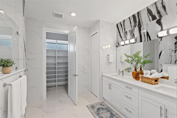 Bathroom, Dual Sink Vanities, Glass Shower, Interior, Marble, Marble Walls, Recessed Lighting, Walk-in Closets