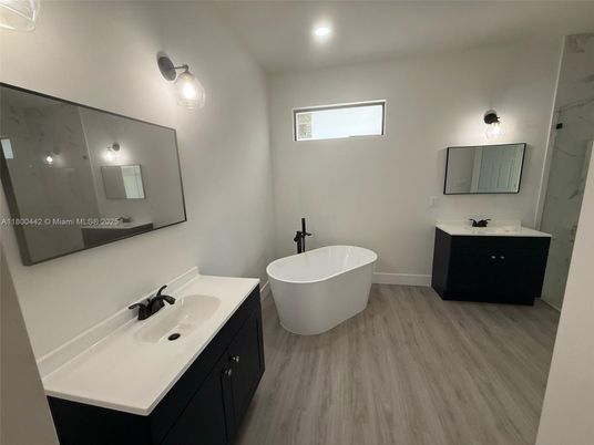 Bathroom, Dual Sink Vanities, Free Standing Baths, Interior, Marble Walls, Recessed Lighting, Wood Texture Flooring