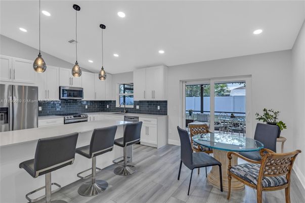 Dining room, Interior, Kitchen, Pendant Lights, Recessed Lighting, Stainless Steel Appliances, Wood Texture Flooring