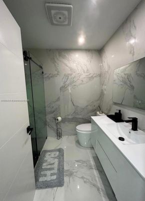 Bathroom, Dual Sink Vanities, Glass Shower, Interior, Marble, Marble Walls, Recessed Lighting