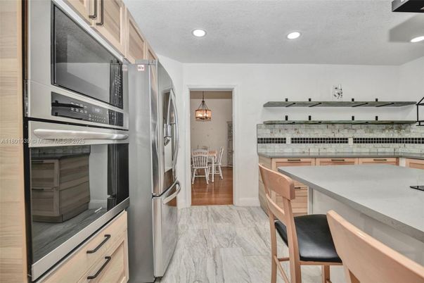 Dining room, Interior, Kitchen, Marble, Pendant Lights, Recessed Lighting, Stainless Steel Appliances, Wood Texture Flooring