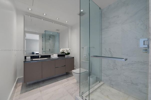 Bathroom, Dual Sink Vanities, Glass Shower, Interior, Marble, Marble Walls, Recessed Lighting