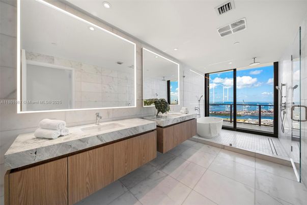 Bathroom, Dual Sink Vanities, Free Standing Baths, Glass Shower, Interior, Marble Walls, Recessed Lighting, Water