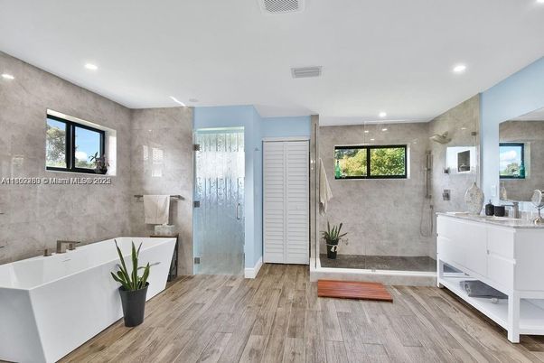 Bathroom, Free Standing Baths, Glass Shower, Interior, Recessed Lighting, Wood Texture Flooring