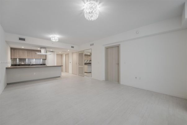 Chandelier, Empty room, Interior, Kitchen, Recessed Lighting, Stainless Steel Appliances, Wood Texture Flooring
