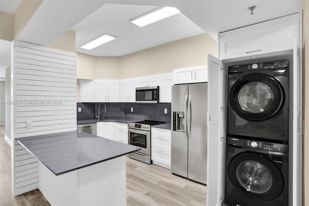 Interior, Kitchen, Recessed Lighting, Stainless Steel Appliances, Utility Closets, Washer, Wood Texture Flooring