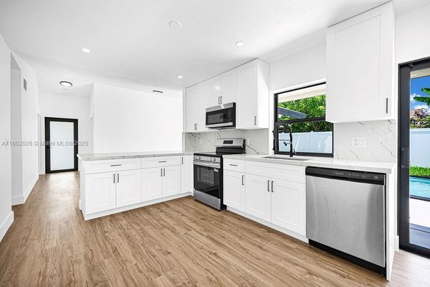 Interior, Kitchen, Marble Walls, Recessed Lighting, Stainless Steel Appliances, Wood Texture Flooring
