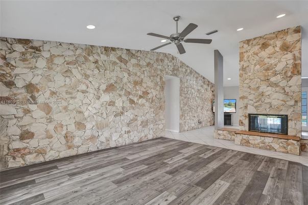 Empty room, Fireplace, Interior, Recessed Lighting, Stone Walls, Wood Texture Flooring