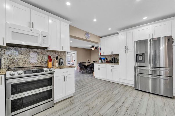Dining room, Interior, Kitchen, Recessed Lighting, Stainless Steel Appliances, Wood Texture Flooring