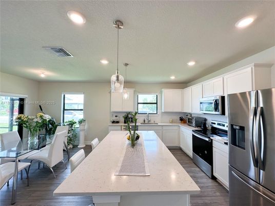 Dining room, Interior, Kitchen, Pendant Lights, Recessed Lighting, Stainless Steel Appliances, Wood Texture Flooring