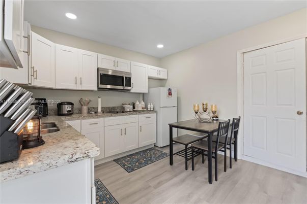 Dining room, Interior, Kitchen, Recessed Lighting, Stainless Steel Appliances, Wood Texture Flooring