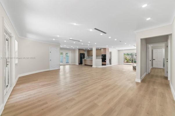 Empty room, Interior, Kitchen, Recessed Lighting, Stainless Steel Appliances, Wood Texture Flooring