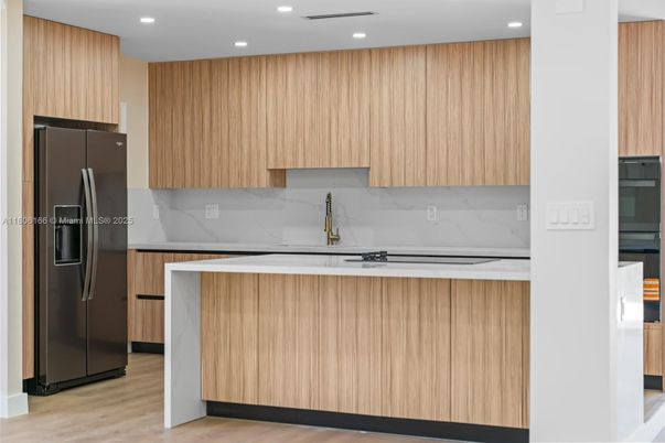 Interior, Kitchen, Marble Walls, Recessed Lighting, Stainless Steel Appliances, Wood Texture Flooring