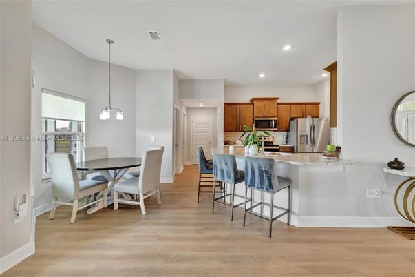 Dining room, Interior, Kitchen, Pendant Lights, Recessed Lighting, Stainless Steel Appliances, Wood Texture Flooring