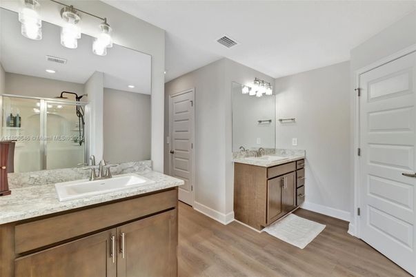 Bathroom, Dual Sink Vanities, Glass Shower, Interior, Recessed Lighting, Wood Texture Flooring