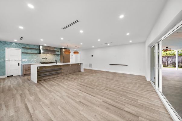 Empty room, Interior, Kitchen, Recessed Lighting, Stainless Steel Appliances, Wood Texture Flooring