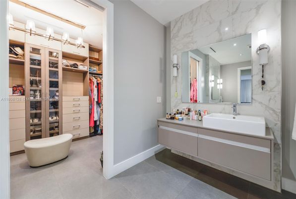 Bathroom, Dual Sink Vanities, Interior, Marble Walls, Recessed Lighting, Walk-in Closets