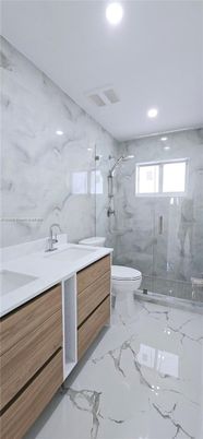 Bathroom, Dual Sink Vanities, Glass Shower, Interior, Marble, Marble Walls, Recessed Lighting
