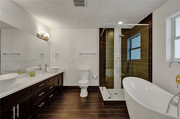 Bathroom, Dual Sink Vanities, Free Standing Baths, Glass Shower, Interior, Recessed Lighting, Wood Texture Flooring