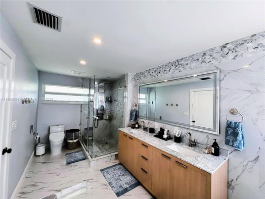 Bathroom, Dual Sink Vanities, Glass Shower, Interior, Marble, Marble Walls, Recessed Lighting