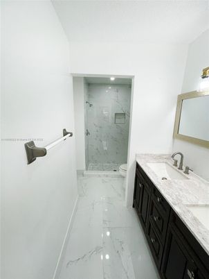 Bathroom, Dual Sink Vanities, Glass Shower, Interior, Marble, Marble Walls, Recessed Lighting