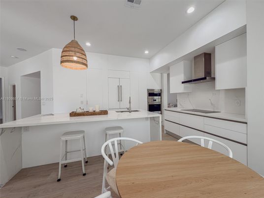 Interior, Kitchen, Marble Walls, Pendant Lights, Recessed Lighting, Stainless Steel Appliances, Wood Texture Flooring