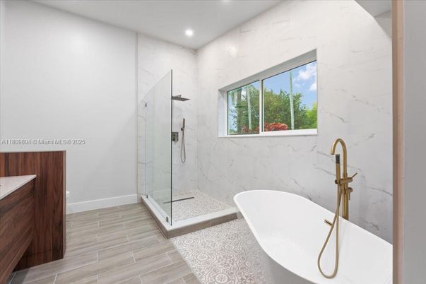 Bathroom, Free Standing Baths, Glass Shower, Interior, Marble Walls, Recessed Lighting, Wood Texture Flooring