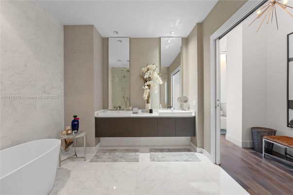Bathroom, Dual Sink Vanities, Free Standing Baths, Interior, Marble, Marble Walls, Recessed Lighting, Wood Texture Flooring