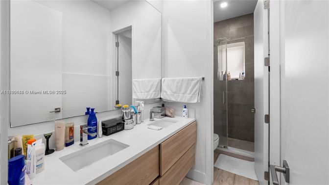Bathroom, Dual Sink Vanities, Glass Shower, Interior, Recessed Lighting, Wood Texture Flooring