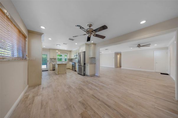 Empty room, Interior, Kitchen, Pendant Lights, Recessed Lighting, Stainless Steel Appliances, Wood Texture Flooring