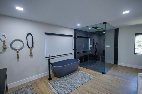 Bathroom, Free Standing Baths, Glass Shower, Interior, Projection Screen, Recessed Lighting, Wood Texture Flooring