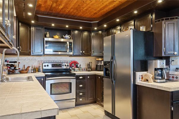 Interior, Kitchen, Recessed Lighting, Stainless Steel Appliances, Tile Countertops, Wooden Ceilings