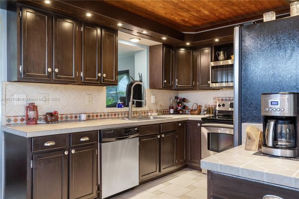 Interior, Kitchen, Recessed Lighting, Stainless Steel Appliances, Tile Countertops, Wooden Ceilings