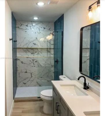 Bathroom, Dual Sink Vanities, Glass Shower, Interior, Marble Walls, Recessed Lighting, Wood Texture Flooring