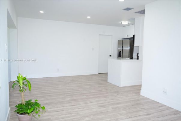 Empty room, Interior, Kitchen, Recessed Lighting, Stainless Steel Appliances, Wood Texture Flooring