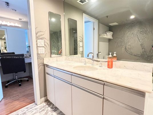 Bathroom, Dual Sink Vanities, Interior, Marble, Marble Walls, Recessed Lighting, Wood Texture Flooring
