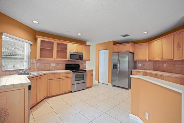 Interior, Kitchen, Recessed Lighting, Stainless Steel Appliances, Tile Countertops