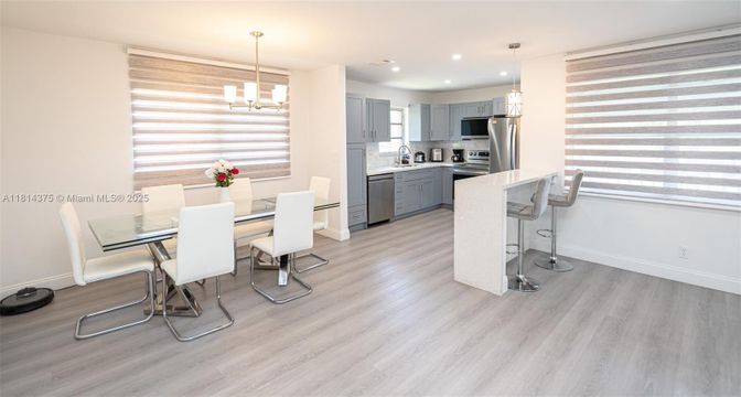Chandelier, Dining room, Interior, Kitchen, Pendant Lights, Recessed Lighting, Stainless Steel Appliances, Wood Texture Flooring